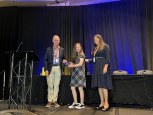 Dr. Stephen Cass awarding Alyssa Tumblin the Super HEARo Award at the International Osseo Meeting in Denver, CO. 